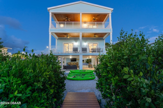 back of property featuring a balcony, ceiling fan, and a patio area