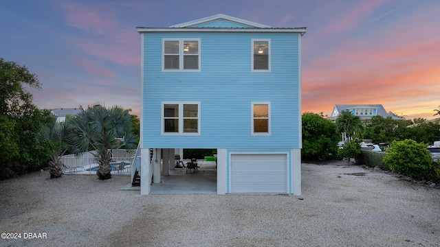 view of back house at dusk