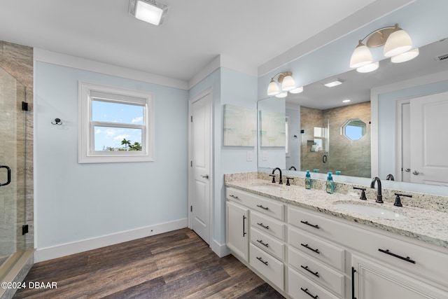 bathroom featuring an enclosed shower, vanity, and hardwood / wood-style flooring