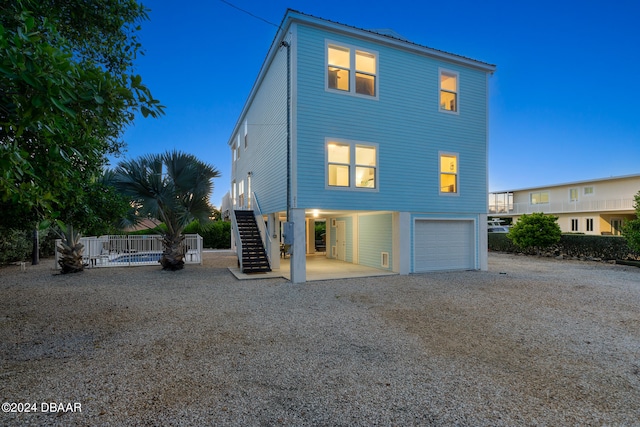 back of property with a garage