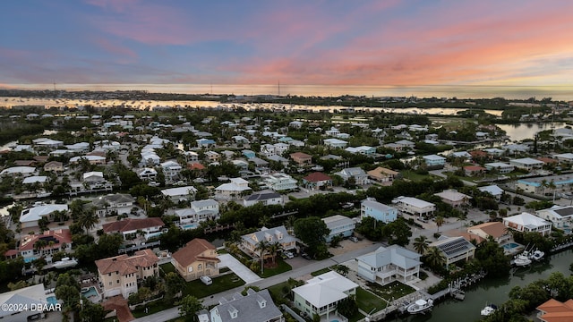 aerial view at dusk with a water view