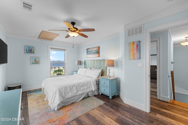 bedroom with dark wood-type flooring, ceiling fan, and crown molding