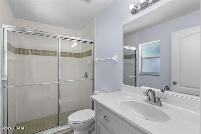 full bath with vanity, toilet, and a shower stall