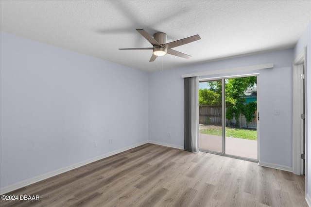 unfurnished room with a ceiling fan, wood finished floors, baseboards, and a textured ceiling