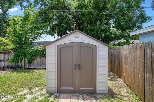 view of shed with fence