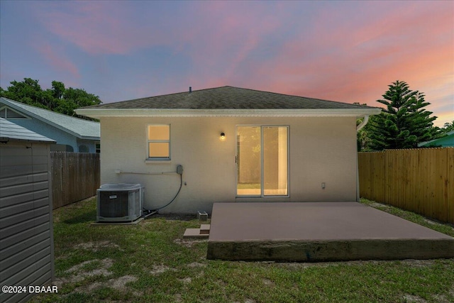 back of house featuring central air condition unit, a patio area, a fenced backyard, and stucco siding