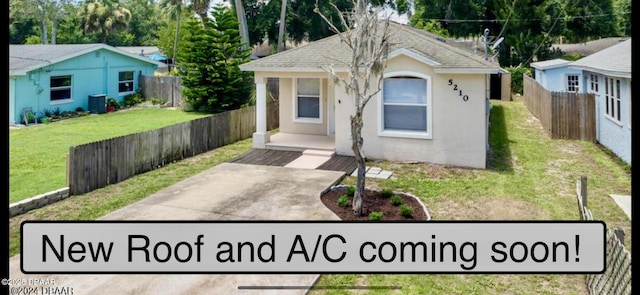 bungalow-style home featuring a front yard, central air condition unit, fence, and stucco siding