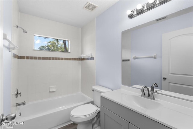 bathroom with vanity, toilet, tub / shower combination, and visible vents