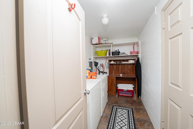 1412 Sunland Rd, Daytona Beach, FL 32114 - washroom featuring washing machine and clothes dryer, concrete block wall, stone finish floor, and laundry area