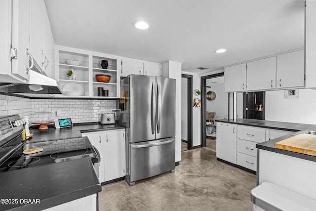 kitchen featuring stainless steel appliances, white cabinets, concrete flooring, dark countertops, and open shelves