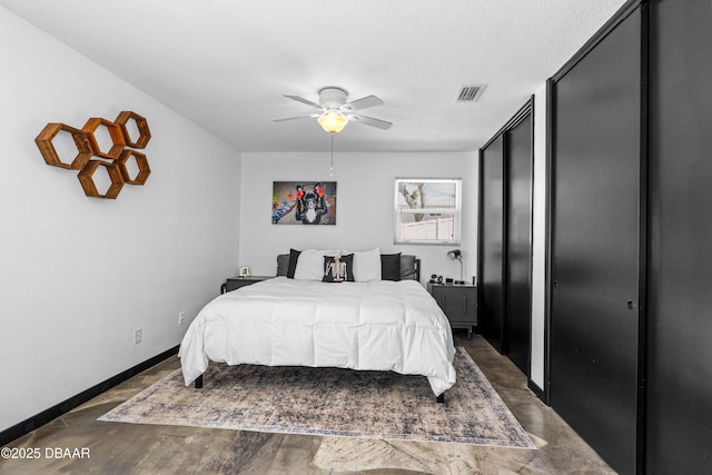 bedroom featuring wood finished floors, a ceiling fan, and baseboards
