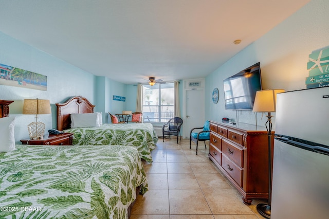 bedroom featuring stainless steel refrigerator and light tile patterned floors