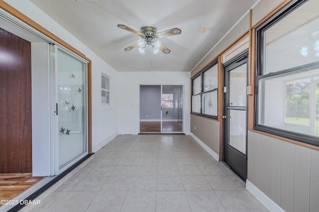 hall with light tile patterned floors and baseboards