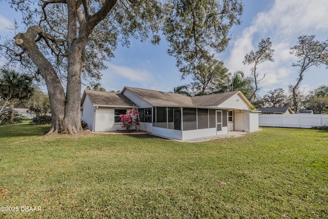 back of house with a yard, fence, and a sunroom