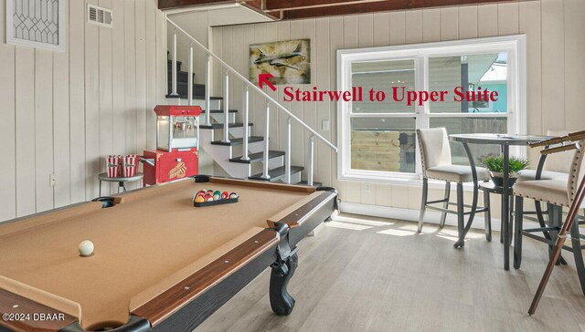 recreation room with hardwood / wood-style floors, wood walls, and pool table