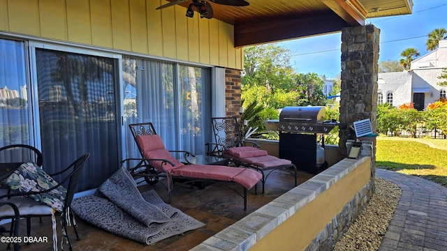 view of patio featuring a grill and a ceiling fan