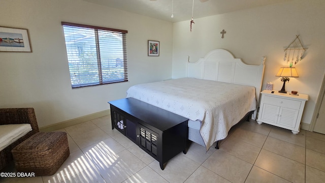 bedroom featuring light tile patterned floors and baseboards