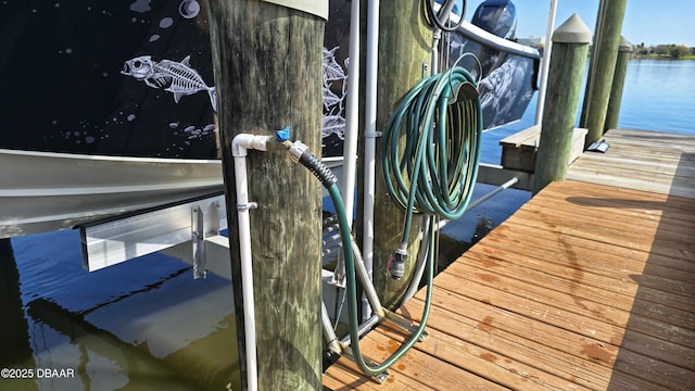 dock area with a water view and boat lift