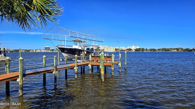 view of dock with boat lift and a water view