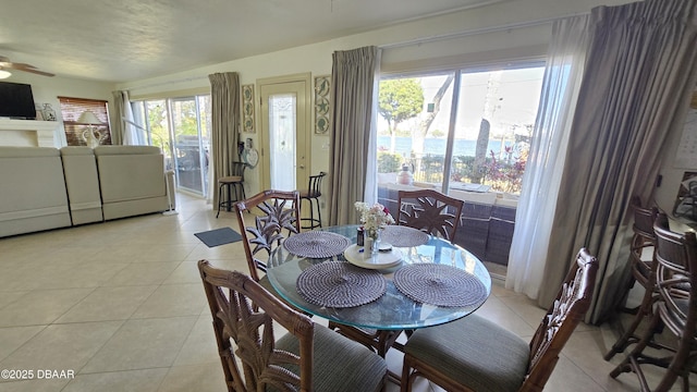 dining space featuring light tile patterned floors, washer and dryer, and ceiling fan