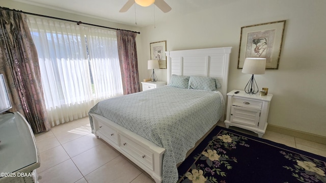 bedroom with light tile patterned floors, baseboards, and a ceiling fan