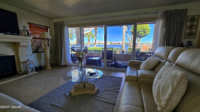 tiled living room with a water view and a fireplace with raised hearth