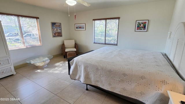 bedroom with baseboards and light tile patterned flooring