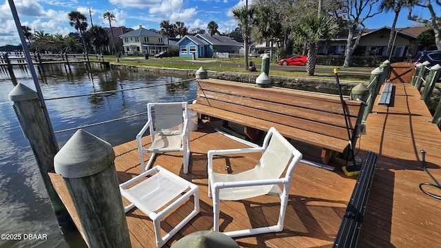 dock area featuring a residential view and a water view