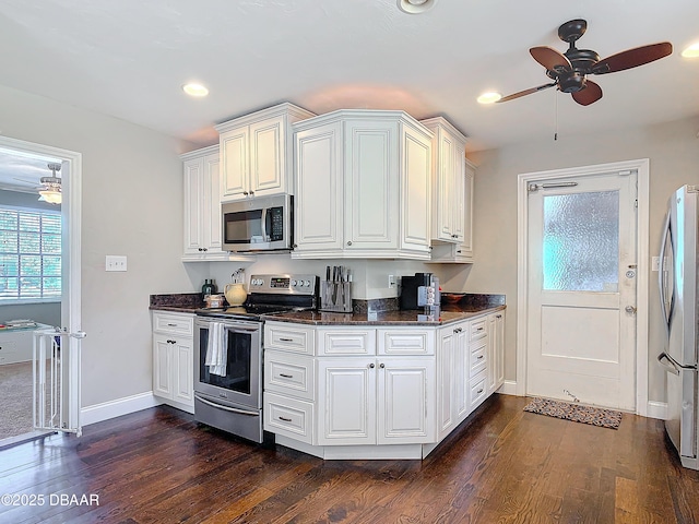 kitchen featuring white cabinetry, ceiling fan, stainless steel appliances, and dark hardwood / wood-style flooring