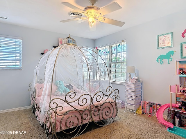 bedroom featuring ceiling fan, carpet floors, and multiple windows