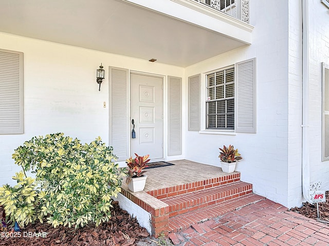 view of exterior entry with a porch