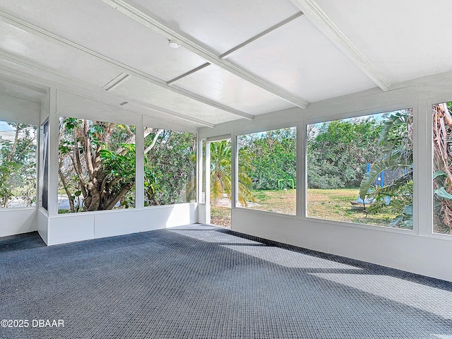 unfurnished sunroom with beam ceiling