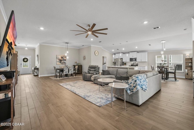 52 Lumber Jack Trl, Palm Coast, FL 32137 - living room with crown molding, wood finished floors, recessed lighting, ceiling fan, and baseboards