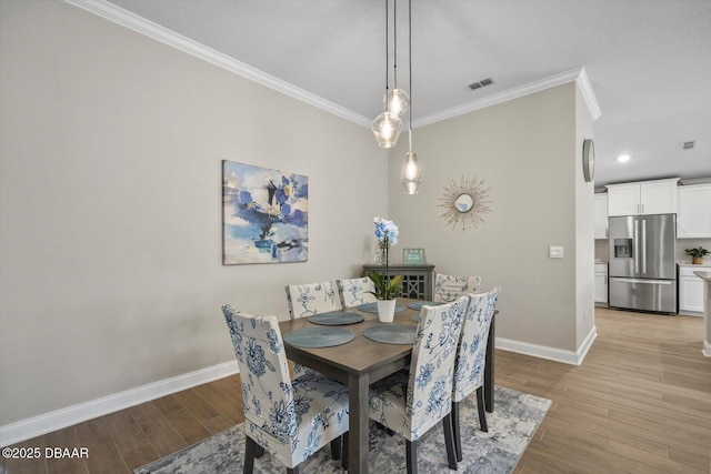 52 Lumber Jack Trl, Palm Coast, FL 32137 - dining room with ornamental molding, light wood-style flooring, baseboards, and recessed lighting