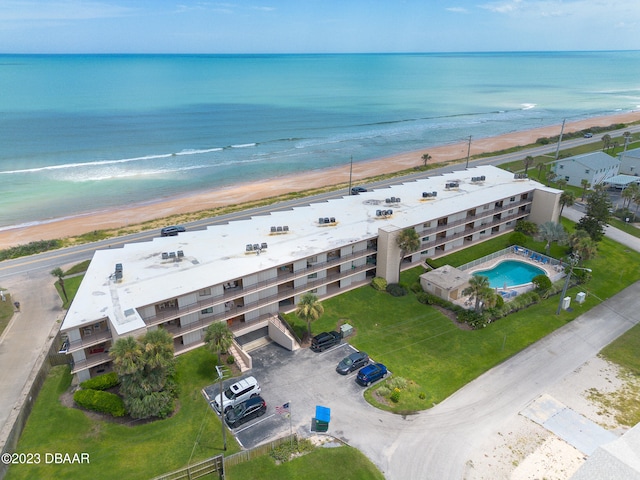 birds eye view of property featuring a view of the beach and a water view