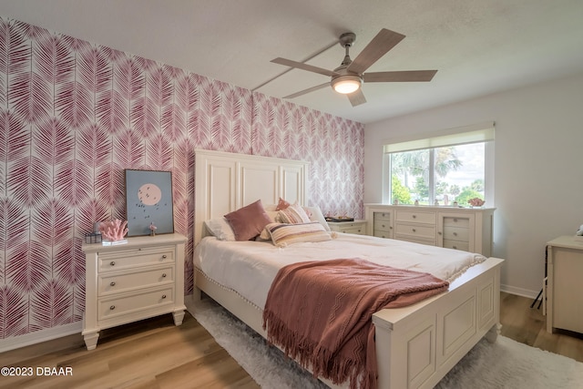 bedroom with ceiling fan and light wood-type flooring