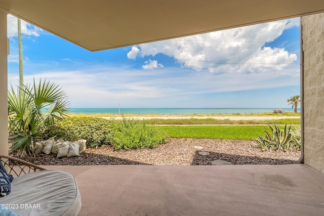 exterior space with a water view and a view of the beach