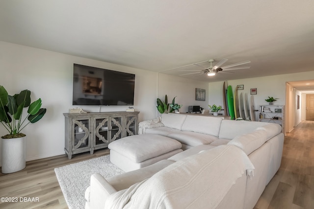 living room featuring light wood-type flooring and ceiling fan