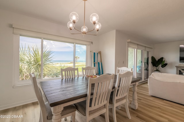 dining area featuring light hardwood / wood-style floors and a chandelier