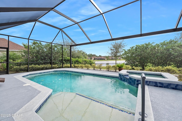 view of pool featuring a water view, a patio area, an in ground hot tub, and glass enclosure