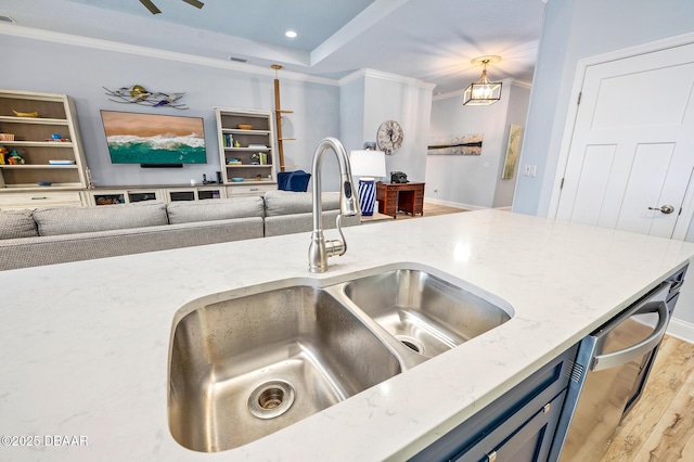 kitchen featuring light hardwood / wood-style flooring, sink, light stone counters, pendant lighting, and ornamental molding