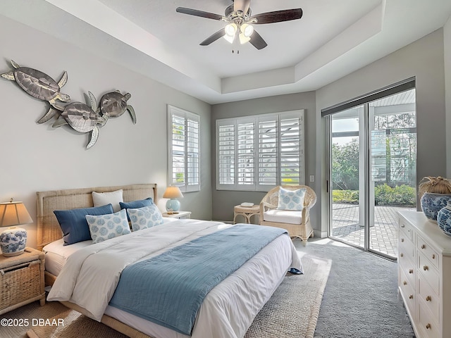 182 Island Breeze Ave, Daytona Beach, FL 32124 - carpeted bedroom with access to outside, a ceiling fan, and a tray ceiling