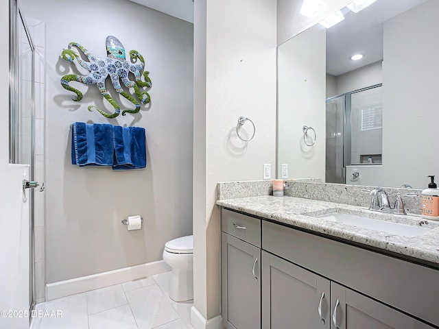 bathroom featuring tile patterned flooring, vanity, toilet, and a shower with door