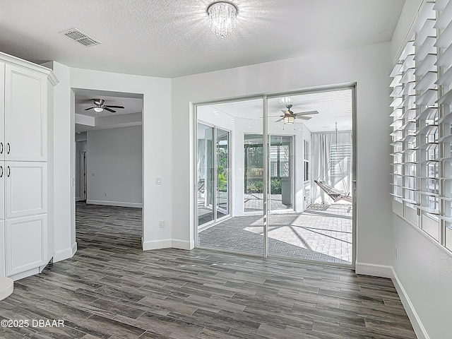 182 Island Breeze Ave, Daytona Beach, FL 32124 - spare room featuring ceiling fan, dark wood finished floors, baseboards, and a textured ceiling