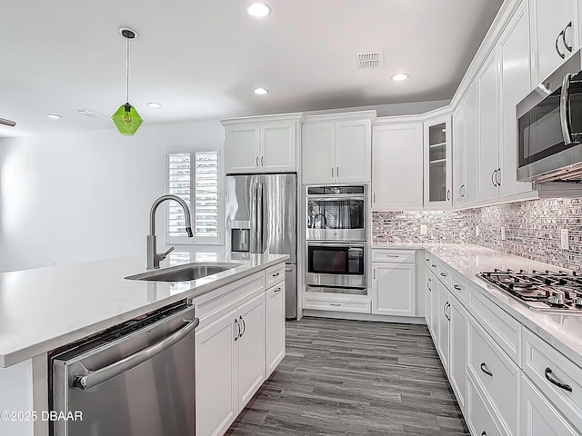 182 Island Breeze Ave, Daytona Beach, FL 32124 - kitchen with stainless steel appliances, a sink, white cabinetry, backsplash, and recessed lighting