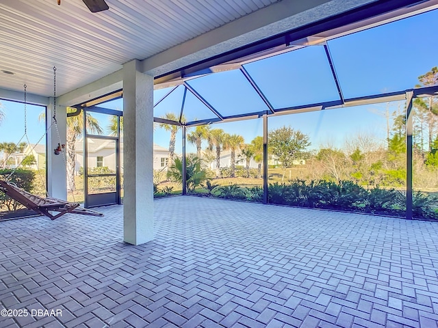 view of patio with glass enclosure