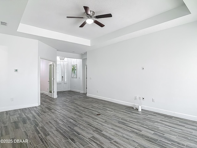 182 Island Breeze Ave, Daytona Beach, FL 32124 - spare room with dark wood-type flooring, ceiling fan, baseboards, and a raised ceiling