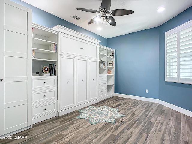 unfurnished bedroom with ceiling fan and dark hardwood / wood-style floors