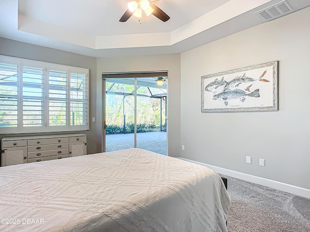 bedroom featuring carpet, ceiling fan, a raised ceiling, and access to outside