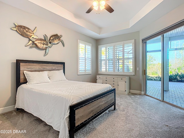 182 Island Breeze Ave, Daytona Beach, FL 32124 - carpeted bedroom featuring access to exterior, multiple windows, baseboards, and a raised ceiling